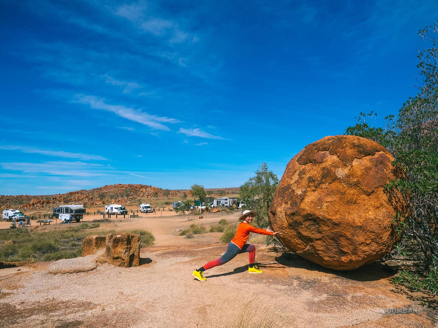 NT Australia - Karlu Karlu - E posing as if she's trying to move the boulder