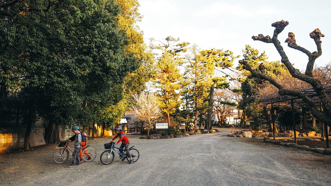 Japan - Gotokuji Temple - Kids cycling around